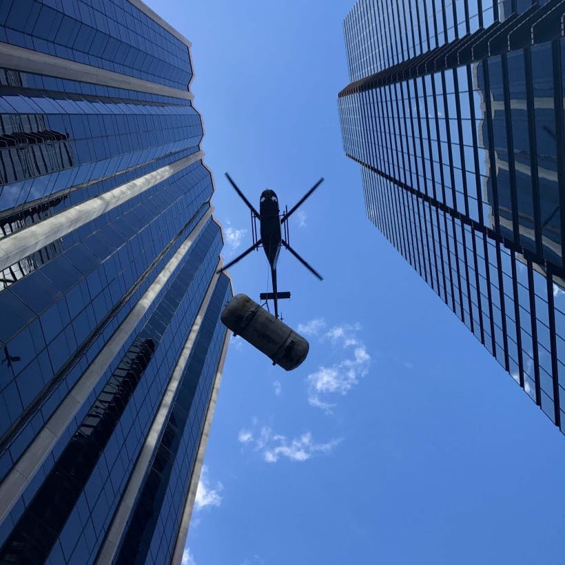 helicopter flying through a city for a construction job 
