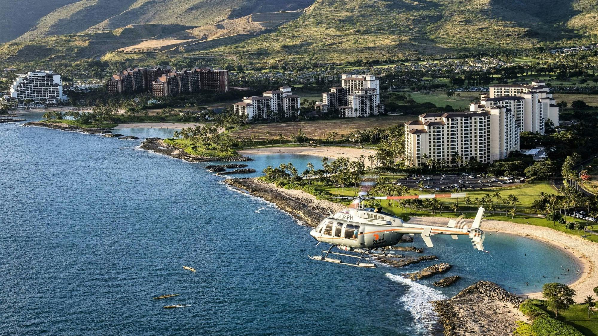 helicopter flying past the oahu coastline with hotels and boats in view