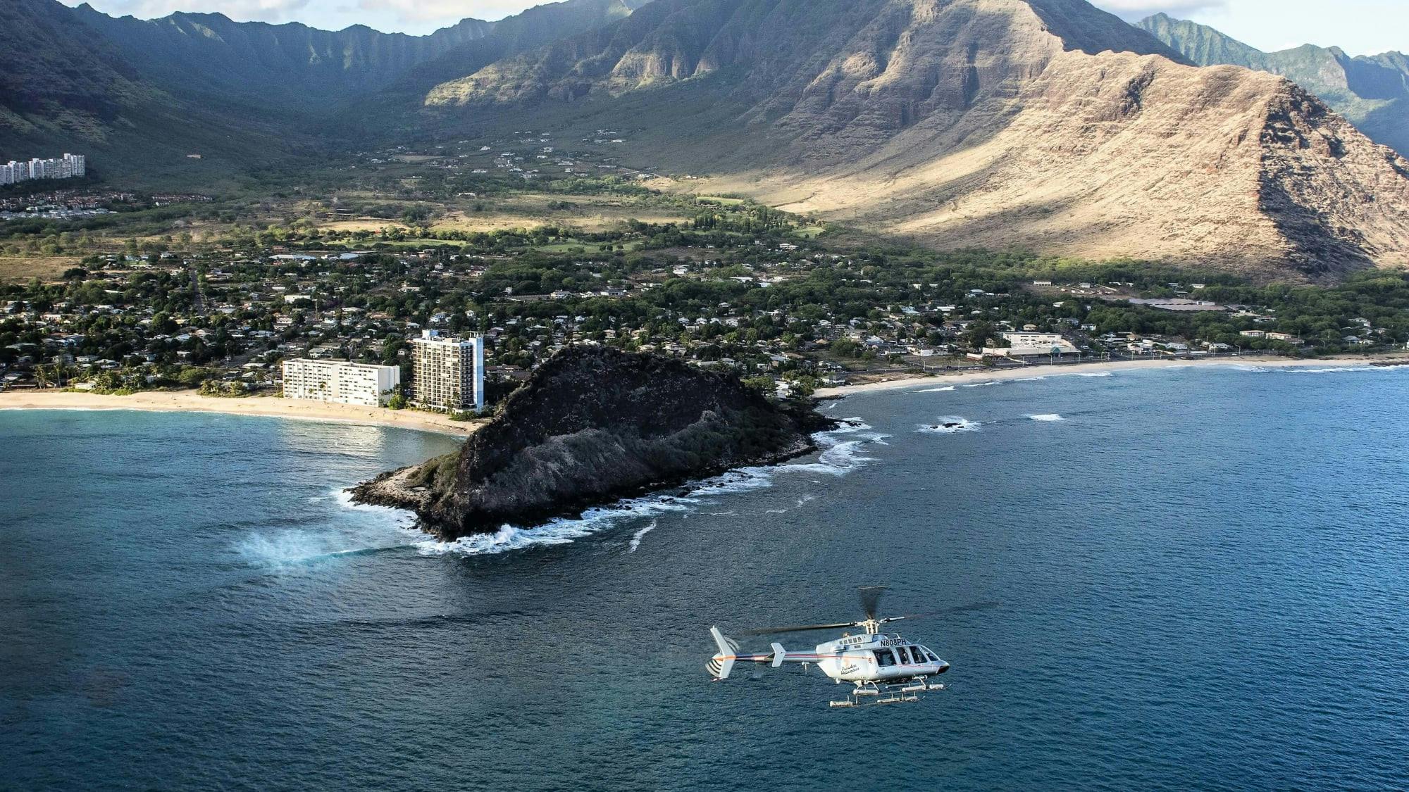helicopter flying by the coast of oahu