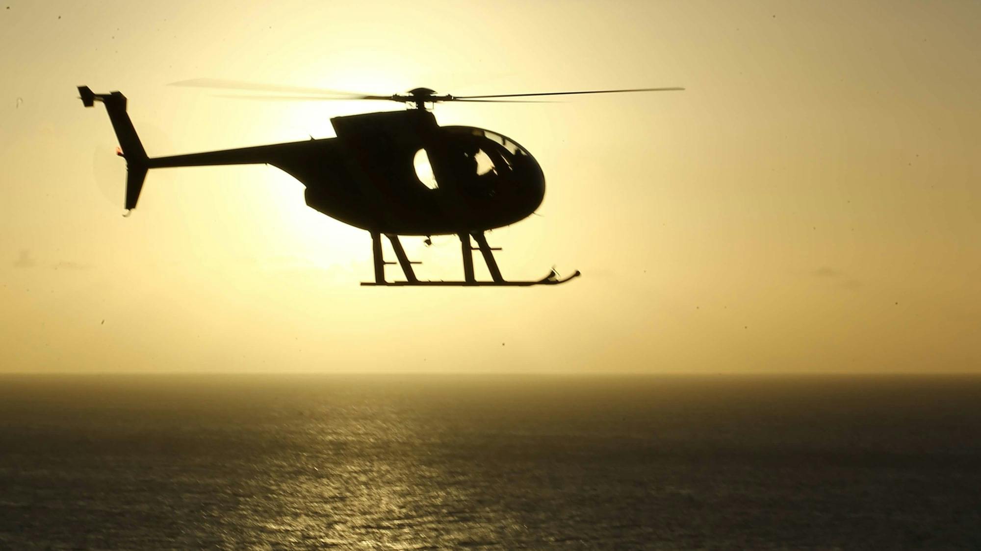 Helicopter flying at sunset