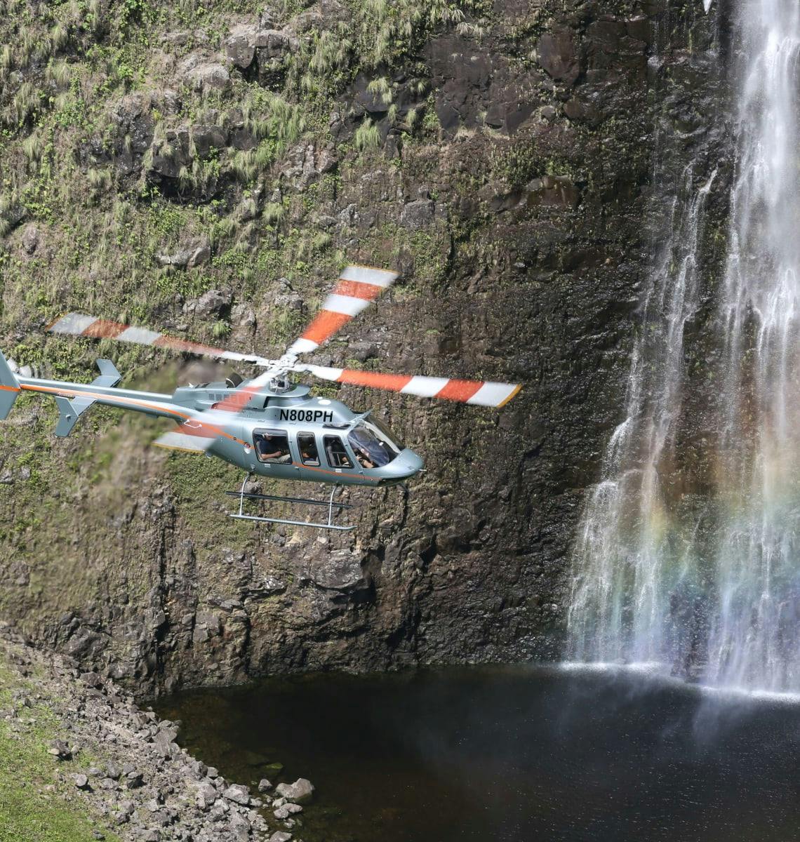 Helicopter flying near a waterfall